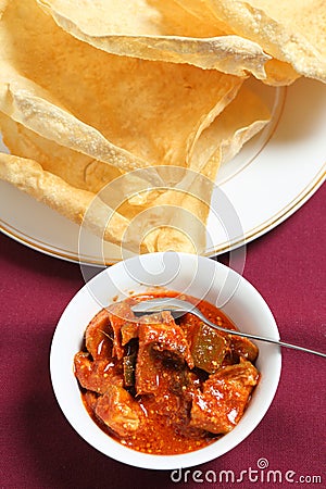 Mango pickle and pappadum vertical Stock Photo