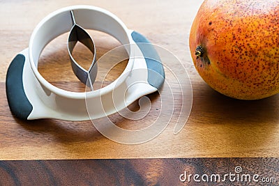 The Mango Splitter slices cleanly through the fruit and leaves almost nothing behind on the seed Stock Photo