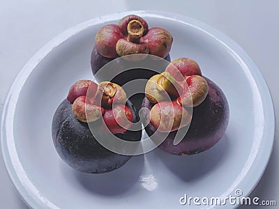 Mangosteen fruit on a white plate Stock Photo