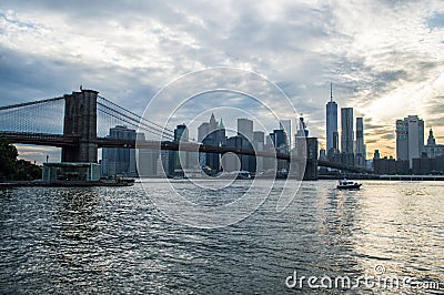 Manhattan Downtown Financial District Skyline and Brooklyn Bridge as Seen from Mainstreet Park in Brooklyn at Sunset Stock Photo