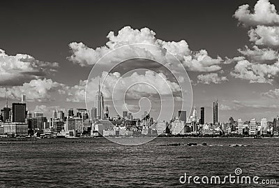 Manhattan Midtown West skyline in Black & White with skyscrapers and clouds in Summer. New York City Stock Photo