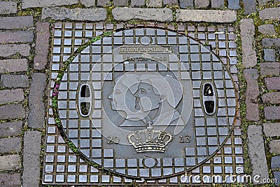 Manhole cover with portraits of the royal pair of the Netherlands Editorial Stock Photo