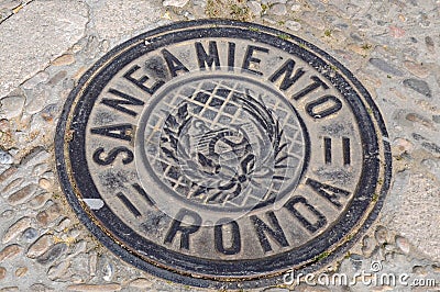 Manhole cover, sewerage, saneamiento, in RONDA Editorial Stock Photo