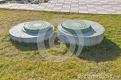 Manhole sewer cleaning system on the ground on a Sunny spring day Stock Photo
