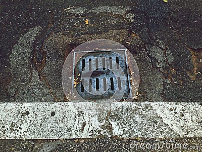 Manhole sewer in a ruined street Stock Photo