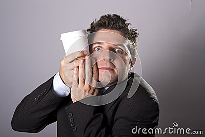 Maniac addict businessman holding take away coffee in caffeine addiction Stock Photo