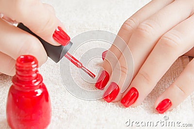 Manicure - Beautiful manicured woman`s nails with red nail polish on soft white towel. Stock Photo