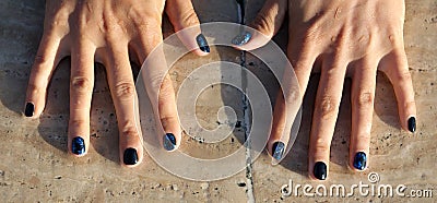 Manicure on the hands of a girl on a stone background Stock Photo