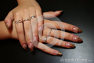 Manicure hands with rings on a black table Stock Photo