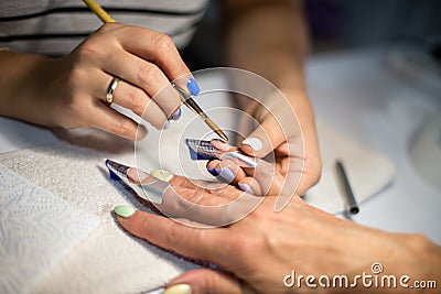 Manicure. Master make nail extension. hands closeup. Editorial Stock Photo