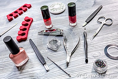 Manicure preparation set with nail polish bottles on gray background Stock Photo