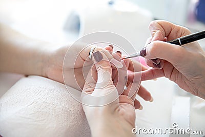 Manicure process in beauty salon - woman hand nails care Stock Photo