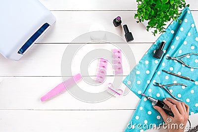 Manicure set and nail polish on wooden background Stock Photo