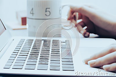 Manicured hand types on laptop keyboard Stock Photo