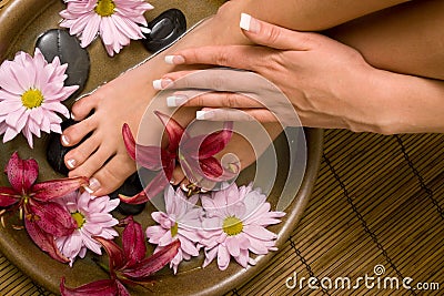 Manicured hands and pedicured feet Stock Photo