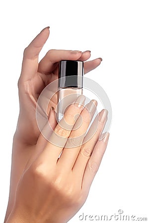 Manicured nails with natural nail polish. Manicure with beige nailpolish. Fashion manicure. Shiny gel lacquer in bottle Stock Photo