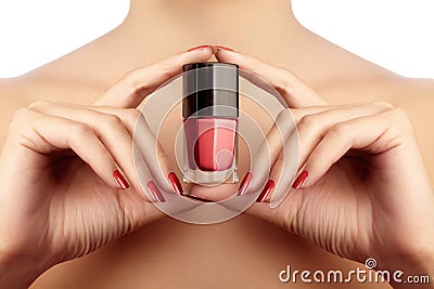 Manicured nails with red nail polish. Manicure with bright nailpolish. Fashion manicure. Shiny gel lacquer in bottle Stock Photo