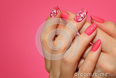 Manicured woman`s nails with pink nailart with flowers. Stock Photo