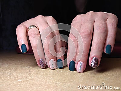 The manicurist excellently made her work a beautiful manicure with a polish gel on her hands and the client is happy Stock Photo