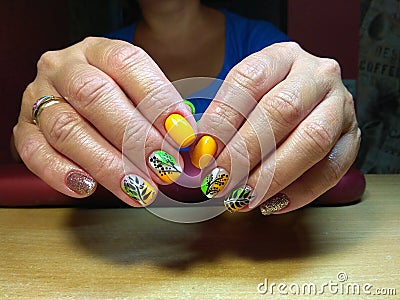 The manicurist excellently made her work a beautiful manicure with a polish gel on her hands and the client is happy Stock Photo