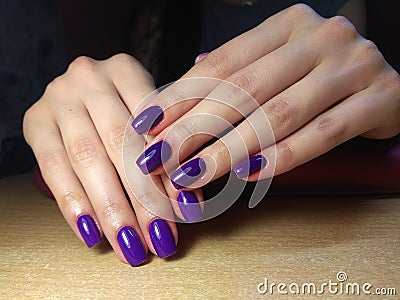 The manicurist excellently made her work a beautiful manicure with a polish gel on her hands and the client is happy Stock Photo