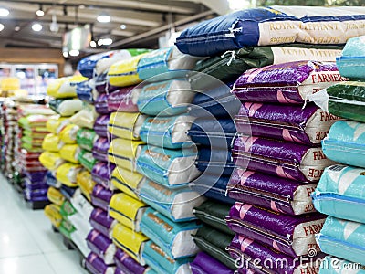 Sacks of various rice brands on display at an aisle in a supermarket Editorial Stock Photo