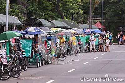 Many philippine tricycles with drivers in road street Editorial Stock Photo
