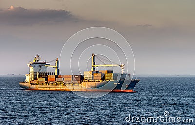 Green Ace container ship sails under sunset light to South Harbor, Manila, Philippines Editorial Stock Photo