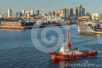 Red tug boat in South Harbor in Manila, Philippines Editorial Stock Photo