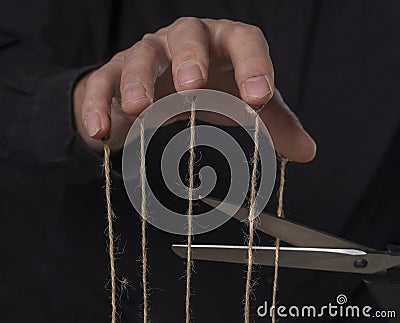 Manipulation concept. Get rid of abuse and authority, cutting strings Stock Photo