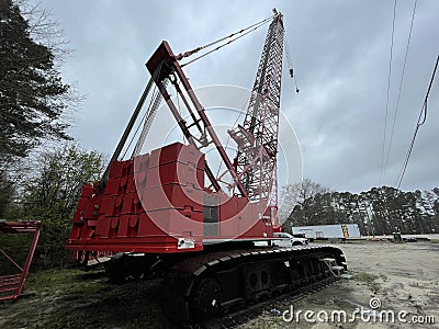 Manitowoc Red Crane Construction scene cloudy rainy day back corner view Editorial Stock Photo
