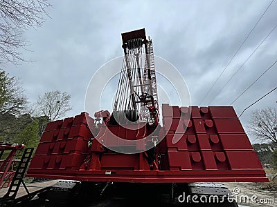 Manitowoc Red Crane Construction scene cloudy rainy day back view weights Editorial Stock Photo
