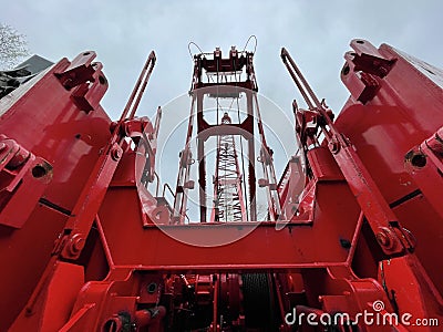 Manitowoc Red Crane Construction scene cloudy rainy day looking up from back Editorial Stock Photo