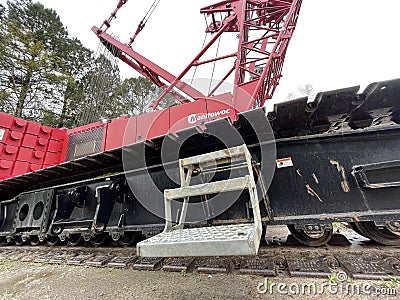 Manitowoc Red Crane Construction scene cloudy rainy day step ladder Editorial Stock Photo