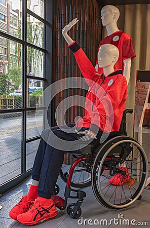 Mannequin depicting a disabled supporter of Japan Paralympic Team sitting on a wheelchair. Editorial Stock Photo