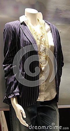 Woman`s blue and white striped jacket over white blouse with sets of pearls adorning neck Stock Photo