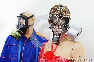 Mannequins man and woman in inlaid gas masks. The concept of air pollution and environmental disruption. Close-up Stock Photo