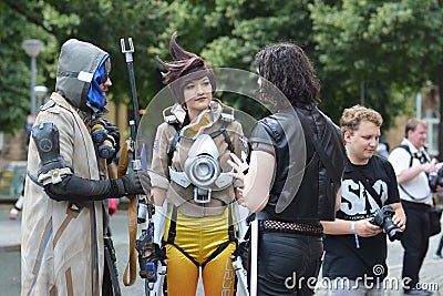 Cosplayers from game `Overwatch` in public park in front of water tower in Mannheim during anual anime and manga convention Editorial Stock Photo