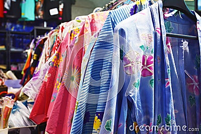 Traditional Japanese female summer garments called `Yukata` with floral patterns on a rack Editorial Stock Photo