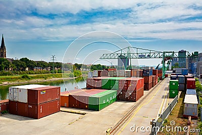 Big industrial container terminal and crates at inland port at Neckar river called `Salzkai` in Mannheim Editorial Stock Photo