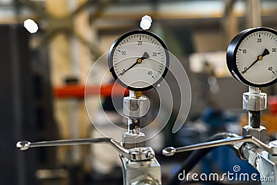 Manometer of the hydraulic control station for the mechanism Stock Photo