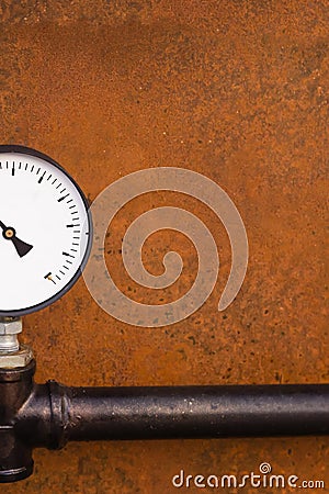 Manometer part and part of a black pipe on a dark brown rusty background design of an old factory with copy space Stock Photo