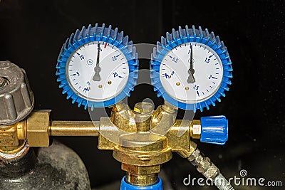 Manometer or pressure gauge with valve and gas cylinder reducer Stock Photo
