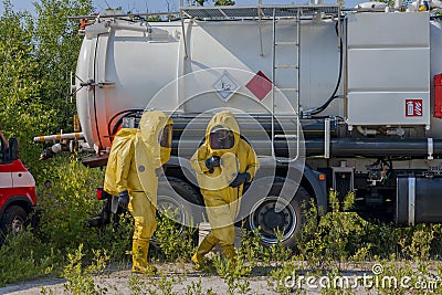 Mans with briefcase in protective hazmat suit. Stock Photo