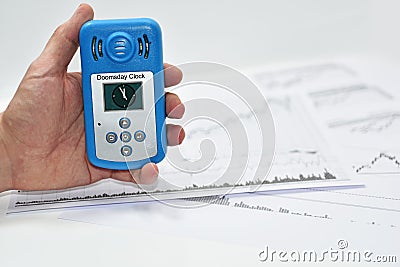 Mans hand with Doomsday Clock meter. Stock Photo