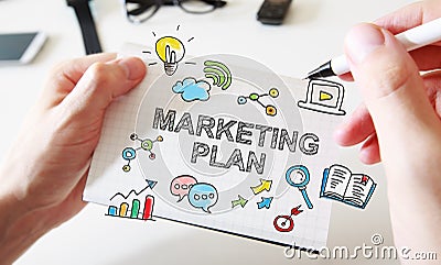 Mans hand drawing Marketing Plan concept on notebook Stock Photo