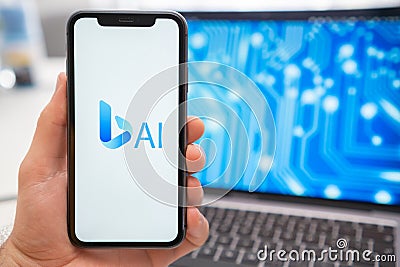A mans hand holding a smartphone with Bing AI neural network logo on the screen Editorial Stock Photo