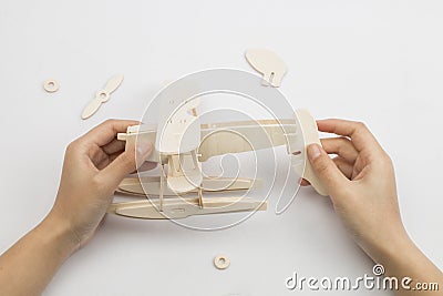 Mans hands assembling wooden hydroplane toy Stock Photo