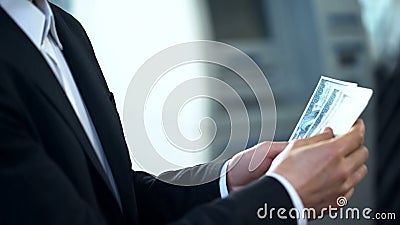 Mans hands counting dollars, illegal business, pyramid scheme, corruption Stock Photo