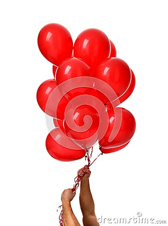 Mans hands hold bunch of big red balloons object for birthday party Stock Photo